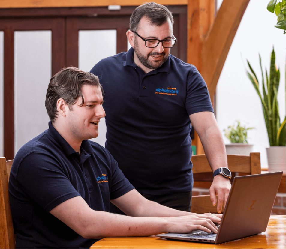 Two Alphabyte IT consultants working together at a laptop